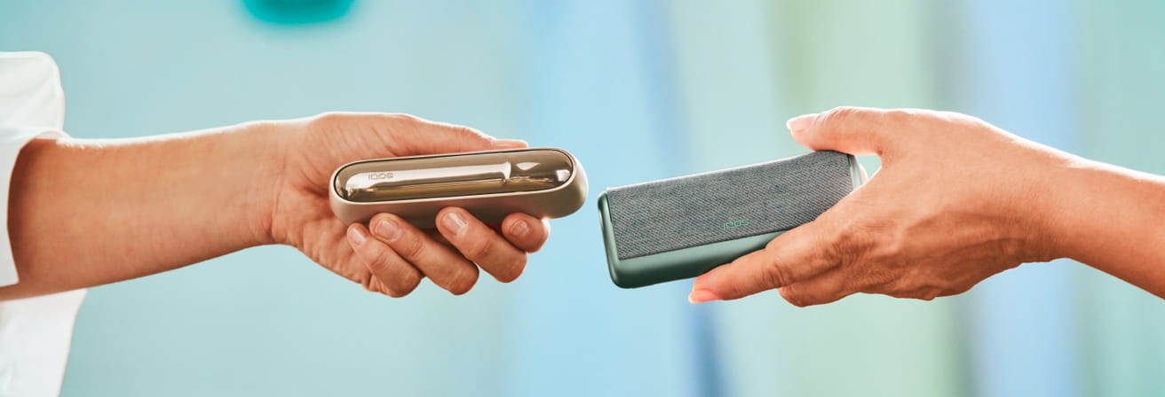 An IQOS DUO and an IQOS ILUMA PRIME being compared